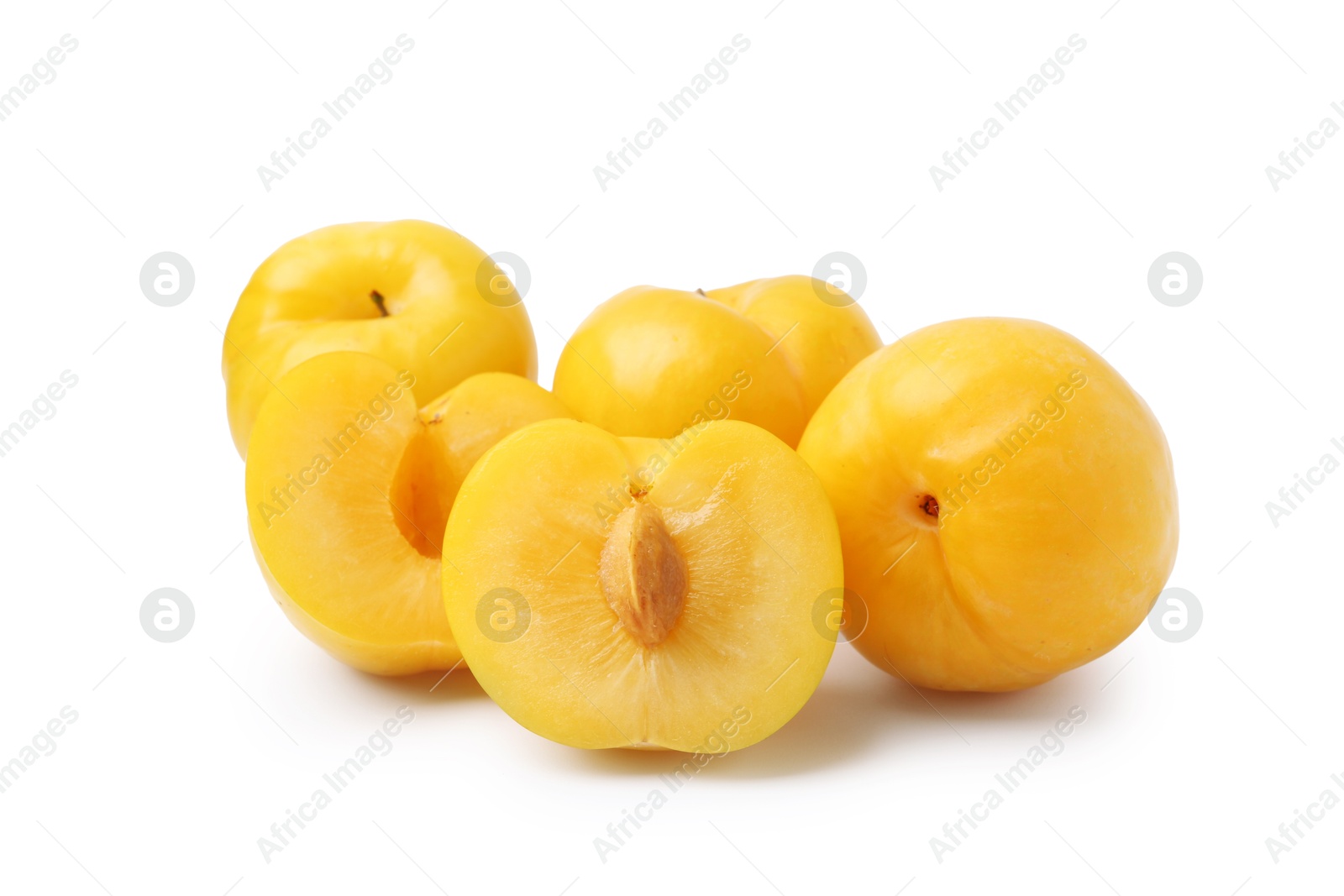 Whole and cut yellow cherry plums isolated on white Photo of Whole and cut yellow cherry plums isolated on white