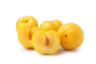 Photo of Whole and cut yellow cherry plums isolated on white