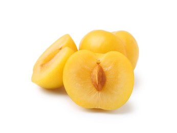 Photo of Whole and cut yellow cherry plums isolated on white