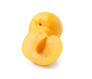 Photo of Whole and cut yellow cherry plums isolated on white
