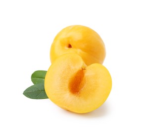 Photo of Whole and cut yellow cherry plums with leaves isolated on white