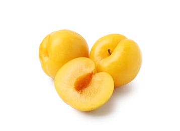 Photo of Whole and cut yellow cherry plums isolated on white