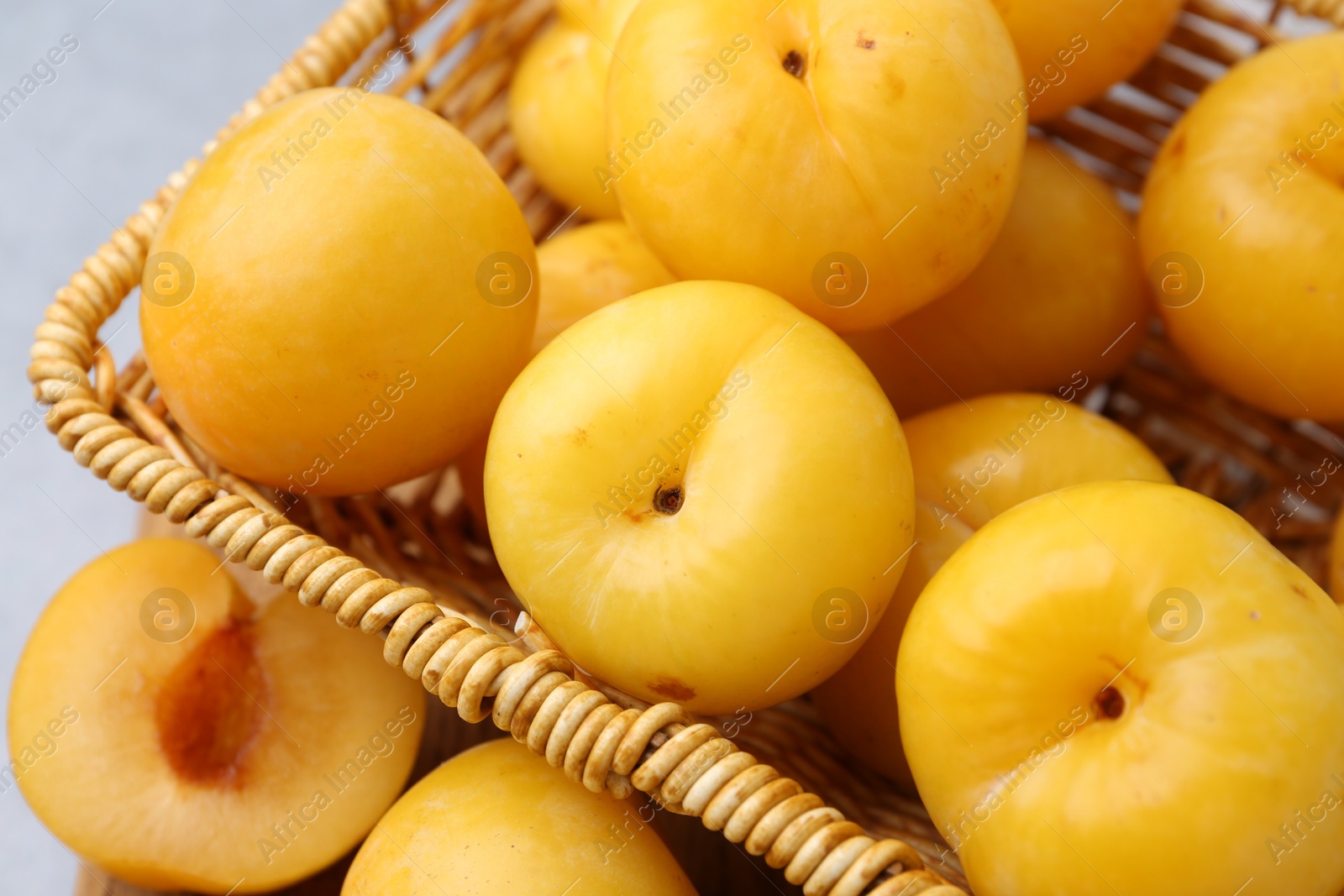 Ripe yellow cherry plums on grey table, closeup Photo of Ripe yellow cherry plums on grey table, closeup