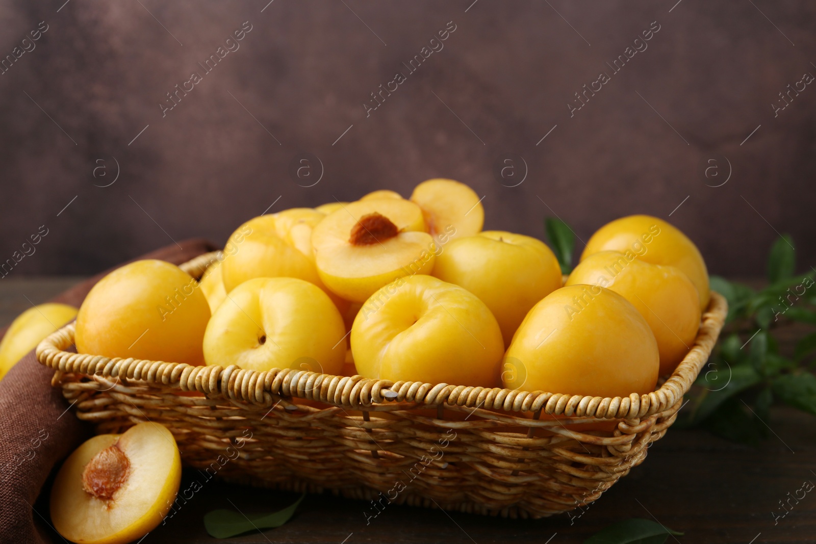 Ripe yellow cherry plums on wooden table, closeup. Space for text Photo of Ripe yellow cherry plums on wooden table, closeup. Space for text