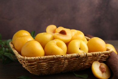 Photo of Ripe yellow cherry plums on wooden table, closeup. Space for text