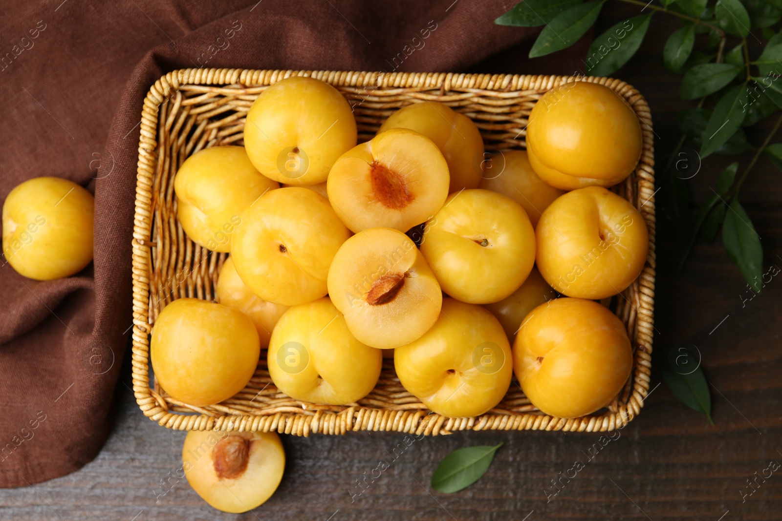 Ripe yellow cherry plums on wooden table, flat lay Photo of Ripe yellow cherry plums on wooden table, flat lay