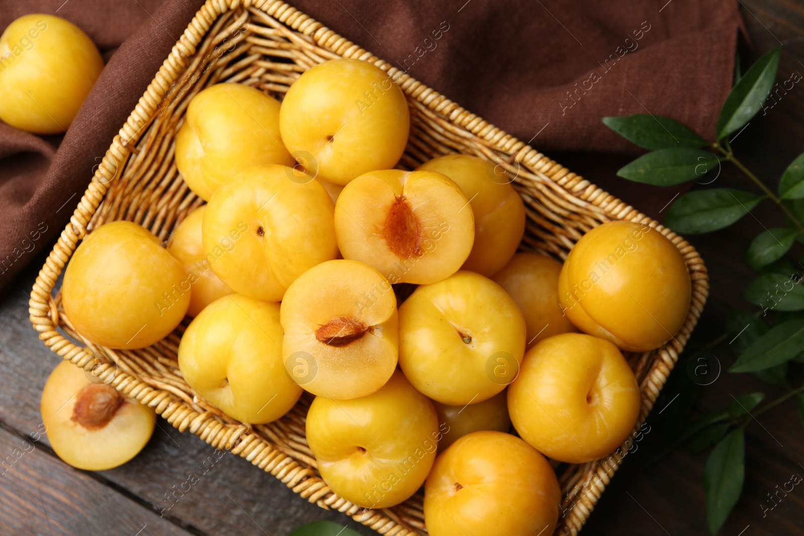 Ripe yellow cherry plums on wooden table, flat lay Photo of Ripe yellow cherry plums on wooden table, flat lay