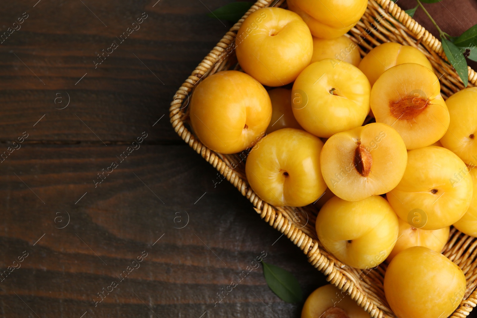 Ripe yellow cherry plums on wooden table, flat lay. Space for text Photo of Ripe yellow cherry plums on wooden table, flat lay. Space for text