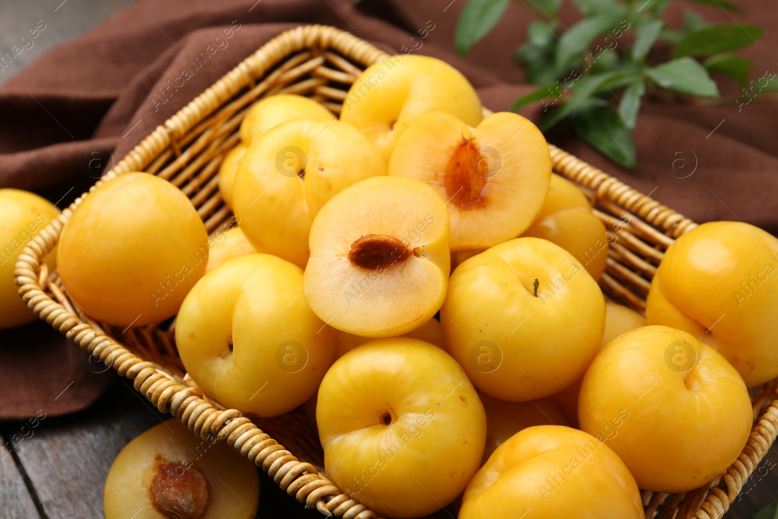 Ripe yellow cherry plums on wooden table, closeup Photo of Ripe yellow cherry plums on wooden table, closeup