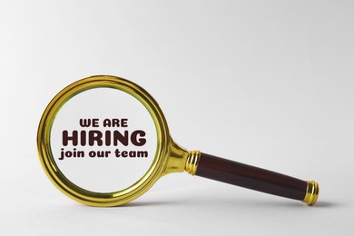 Image of We are hiring, join our team. Magnifying glass with inscription inside on white background