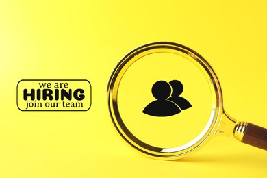 Image of We are hiring, join our team. Magnifying glass with human icon inside on yellow background