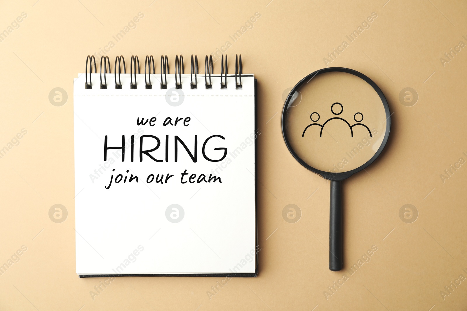 We are hiring, join our team. Notebook with inscription and magnifying glass on beige background, top view Image of We are hiring, join our team. Notebook with inscription and magnifying glass on beige background, top view