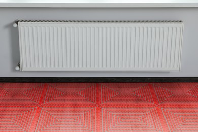 Image of Underfloor heating system, double exposure with laminate floor in room