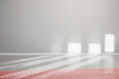 Image of Underfloor heating system, double exposure with laminate floor in room