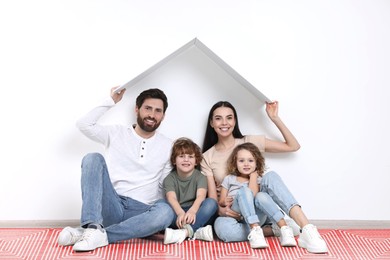 Image of Happy family on warm floor at home, double exposure with underfloor heating system