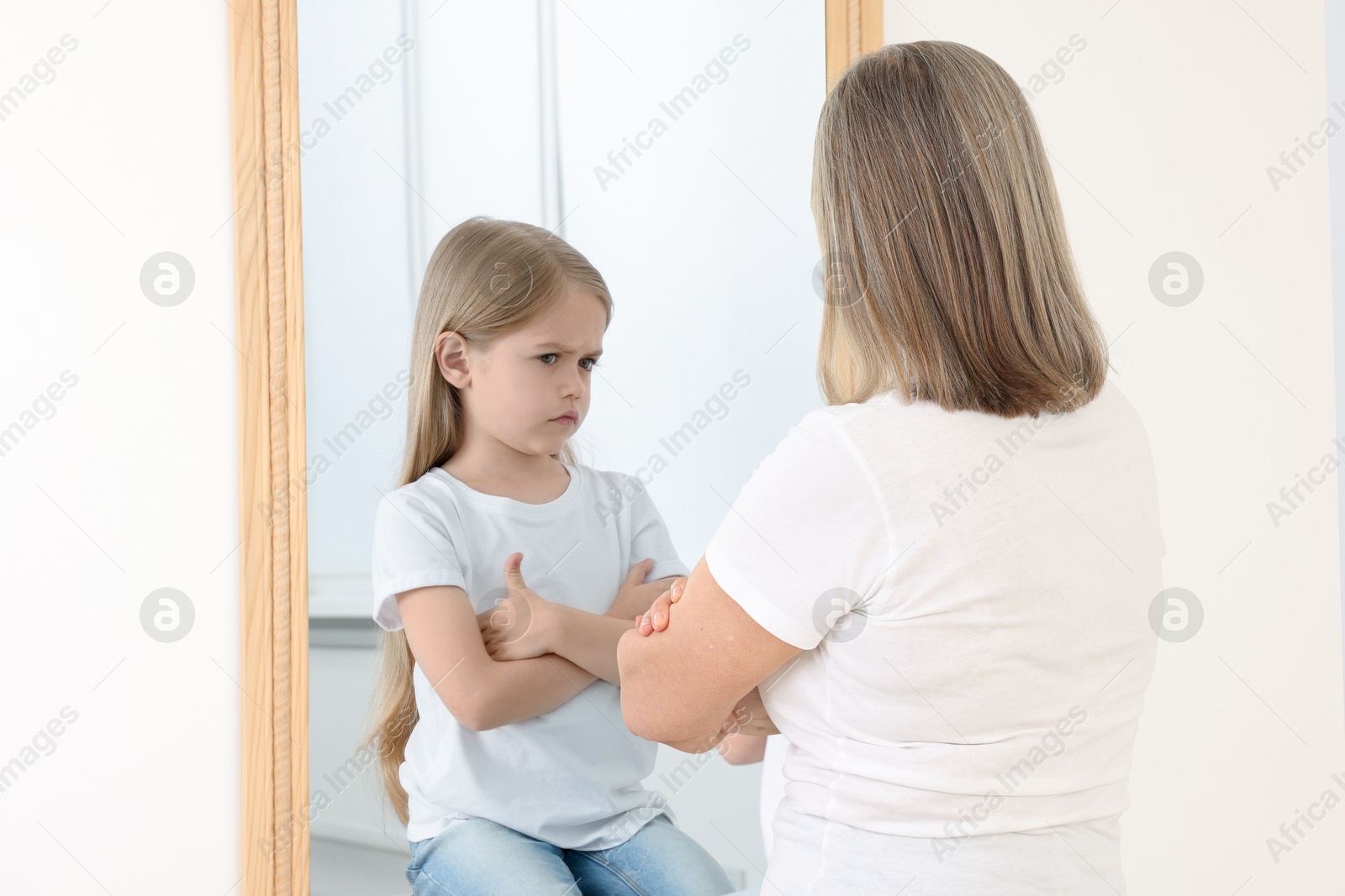 Senior woman seeing herself as child in mirror. Conceptual collage about past and future, flow of time, age Image of Senior woman seeing herself as child in mirror. Conceptual collage about past and future, flow of time, age