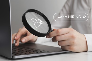 Image of We are hiring, inscription in search bar. Woman with magnifying glass working on laptop at table, closeup