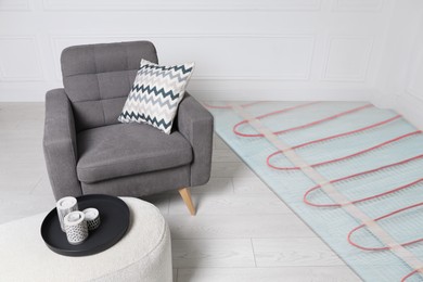 Image of Underfloor heating system, double exposure with laminate floor in room