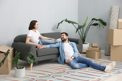 Image of Couple at home, double exposure with underfloor heating system