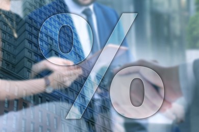 Image of Percent sign, building and businesspeople, double exposure