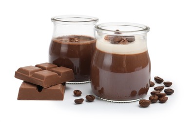 Photo of Delicious panna cotta, coffee beans and chocolate pieces isolated on white