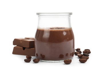 Photo of Delicious chocolate panna cotta in glass jar, coffee beans and chocolate pieces isolated on white