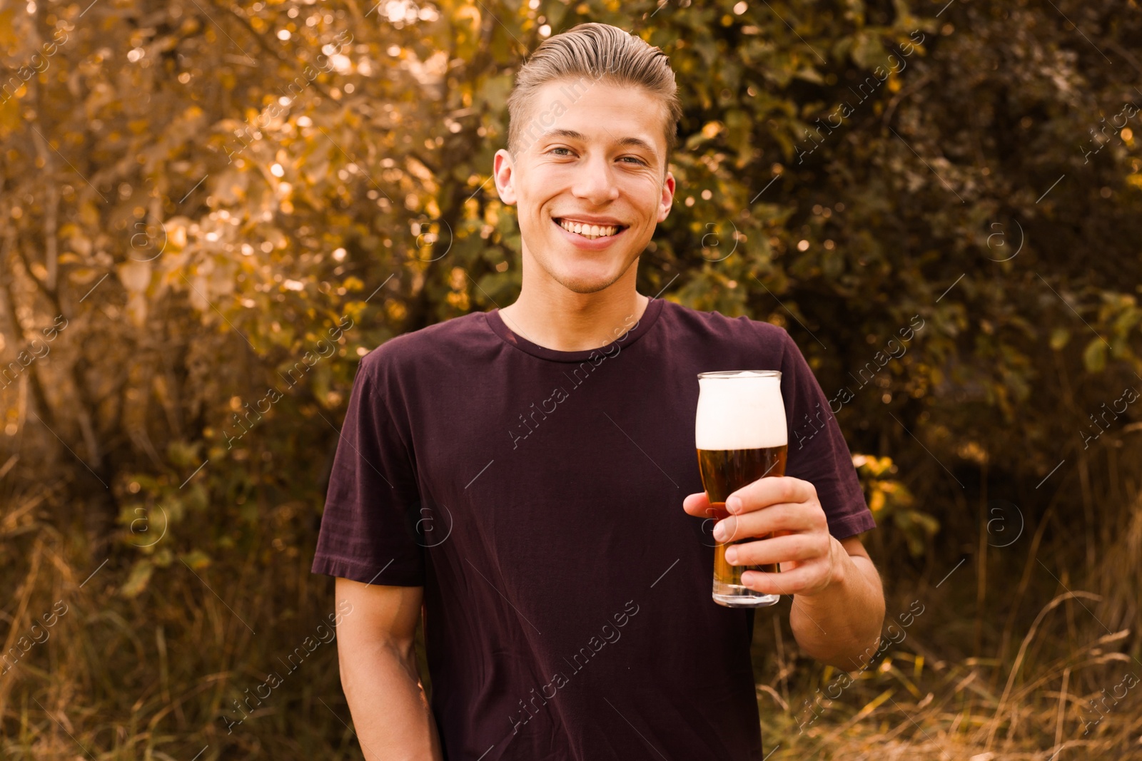 Photo of Young man with glass of beer outdoors