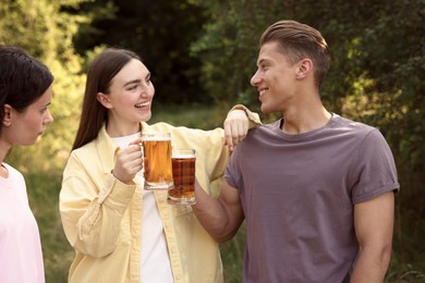 Photo of Group of happy friends having fun and drinking beer outdoors