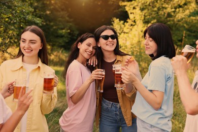 Photo of Group of happy friends having fun and drinking beer outdoors