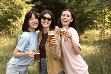 Photo of Group of happy friends having fun and drinking beer outdoors