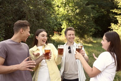 Photo of Group of happy friends having fun and drinking beer outdoors