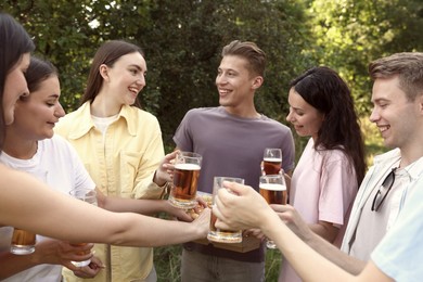Photo of Group of happy friends with pizza having fun and drinking beer outdoors