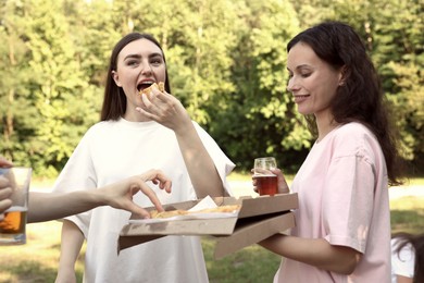 Photo of Group of happy friends having fun and drinking beer outdoors