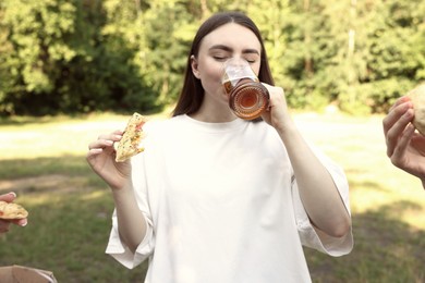 Photo of Group of happy friends having fun and drinking beer outdoors