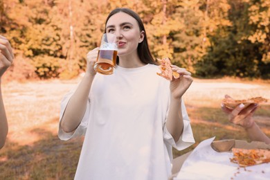 Photo of Group of happy friends having fun and drinking beer outdoors