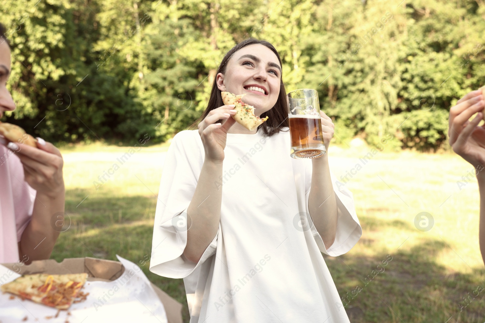 Group of happy friends having fun and drinking beer outdoors Photo of Group of happy friends having fun and drinking beer outdoors