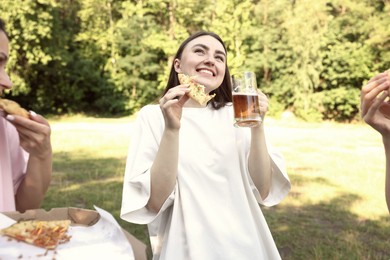 Photo of Group of happy friends having fun and drinking beer outdoors