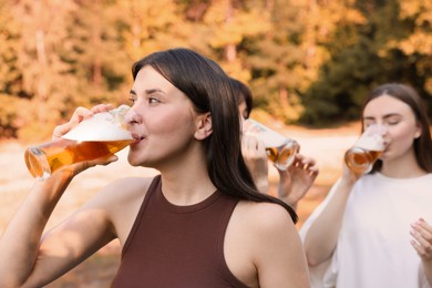 Photo of Group of happy friends having fun and drinking beer outdoors