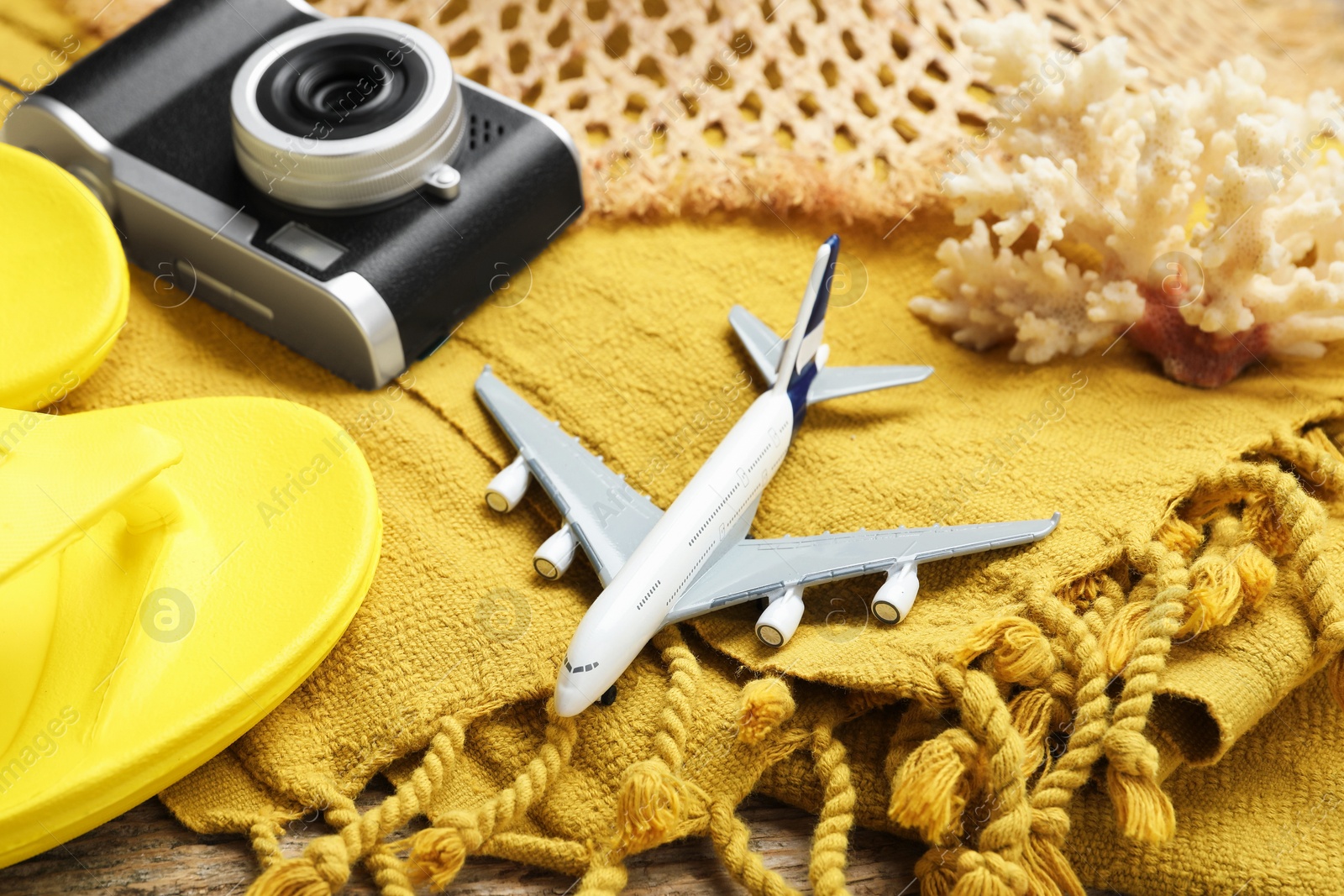 Photo of Toy plane, camera and beach accessories, closeup. Time for summer vacation