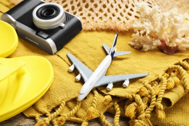 Photo of Toy plane, camera and beach accessories, closeup. Time for summer vacation