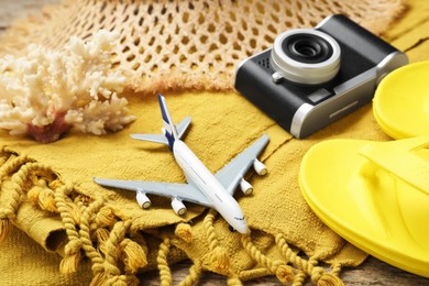 Photo of Toy plane, camera and beach accessories, closeup. Time for summer vacation