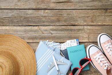 Photo of Flat lay composition with passports and flight tickets on wooden background, space for text. Time for summer vacation