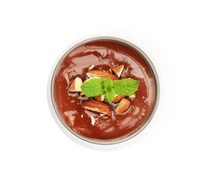 Photo of Delicious chocolate panna cotta with almonds and mint in glass isolated on white, top view