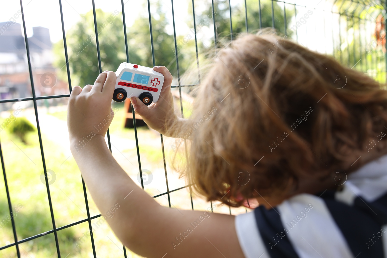Little boy playing with toy car outdoors, closeup Photo of Little boy playing with toy car outdoors, closeup
