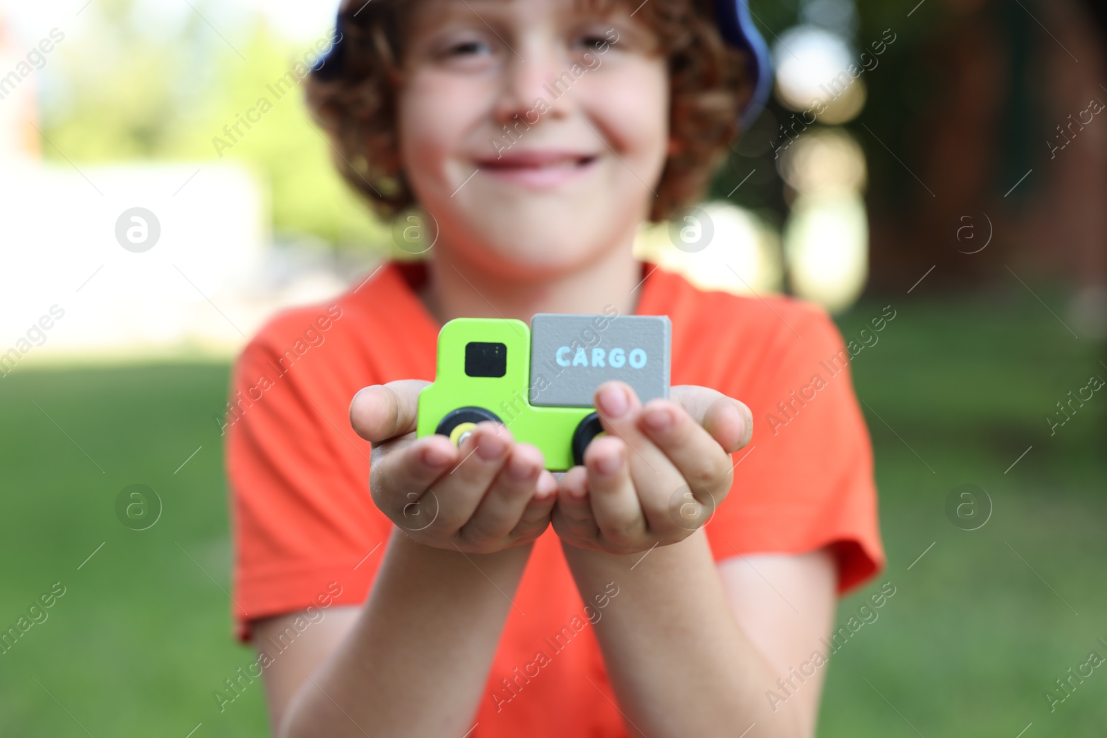 Little boy with toy car outdoors, selective focus Photo of Little boy with toy car outdoors, selective focus