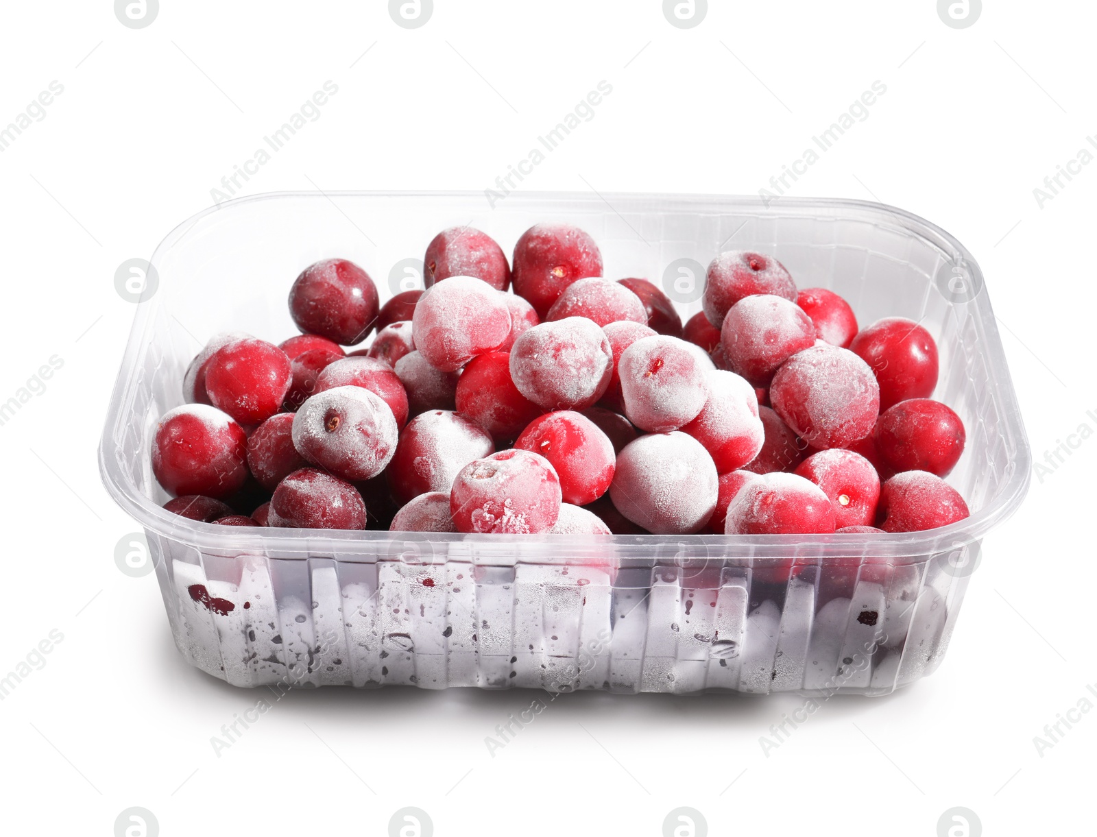 Photo of Ripe frozen cherries in plastic container isolated on white