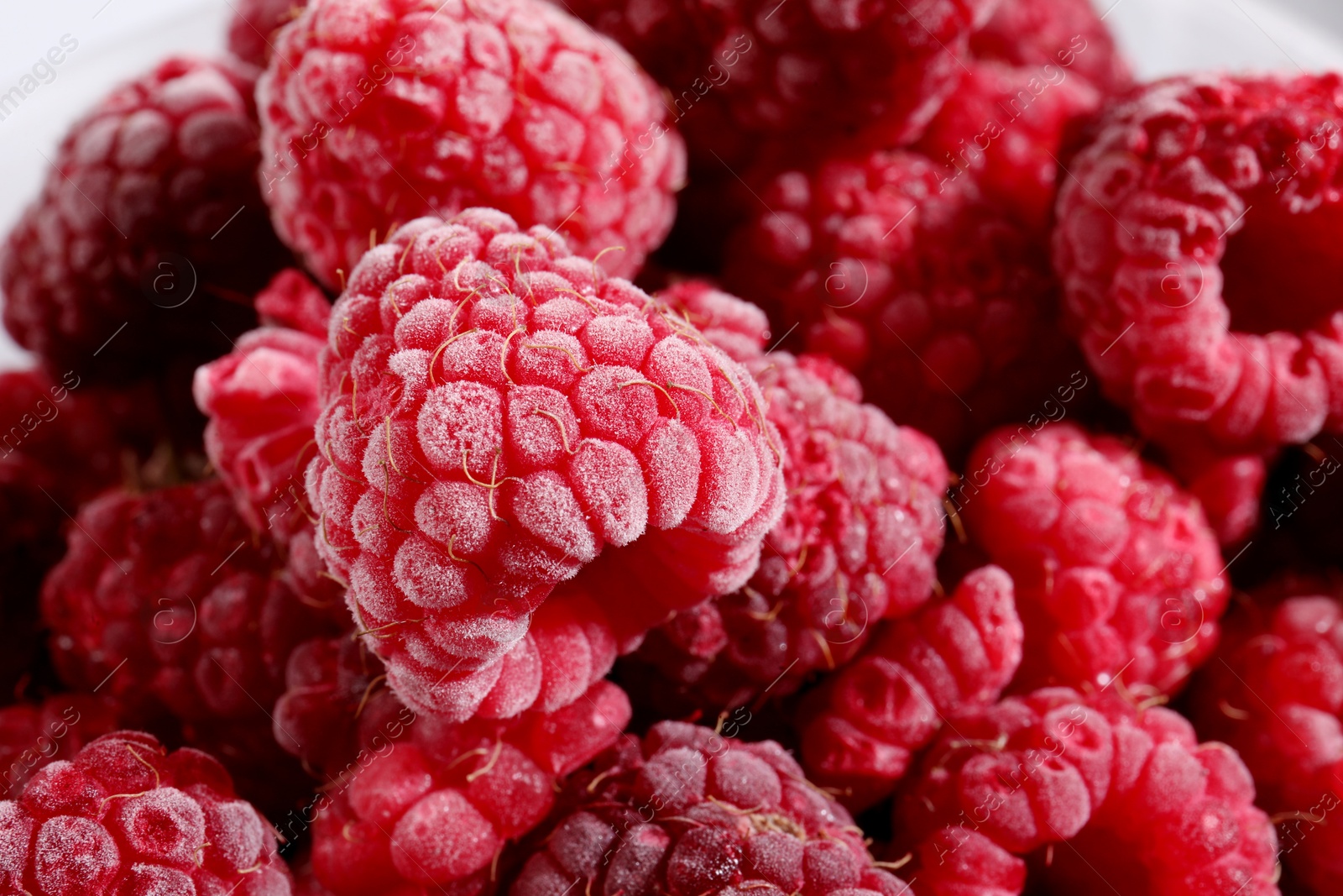 Photo of Many ripe frozen raspberries as background, closeup
