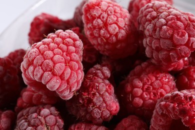 Photo of Many ripe frozen raspberries on light background, closeup