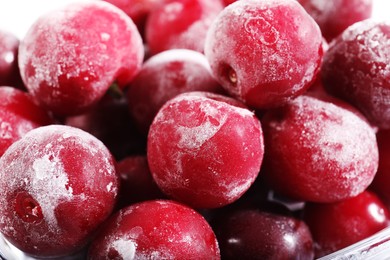Photo of Ripe frozen cherries on light background, closeup