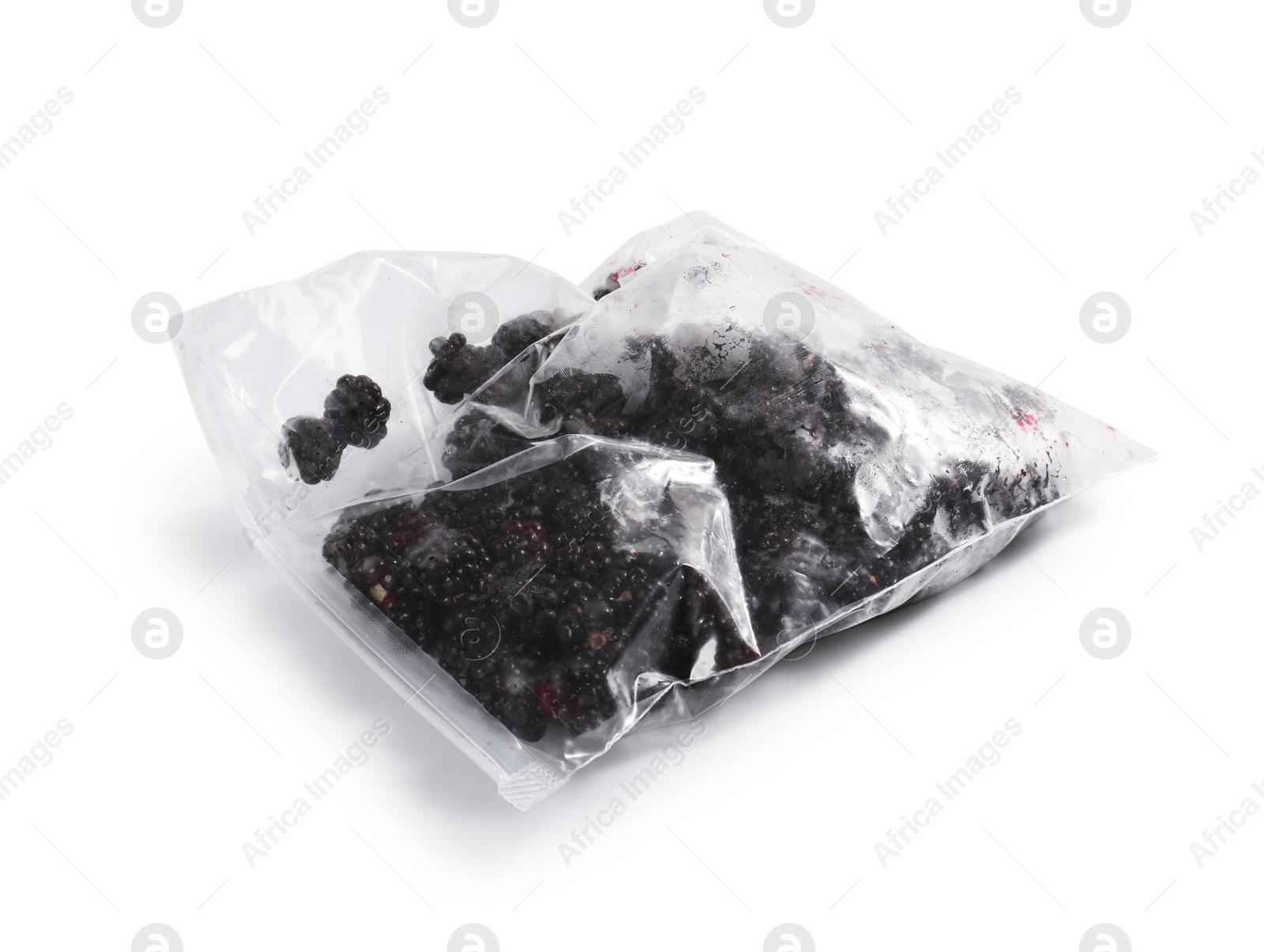 Photo of Ripe frozen blackberries in plastic bag isolated on white